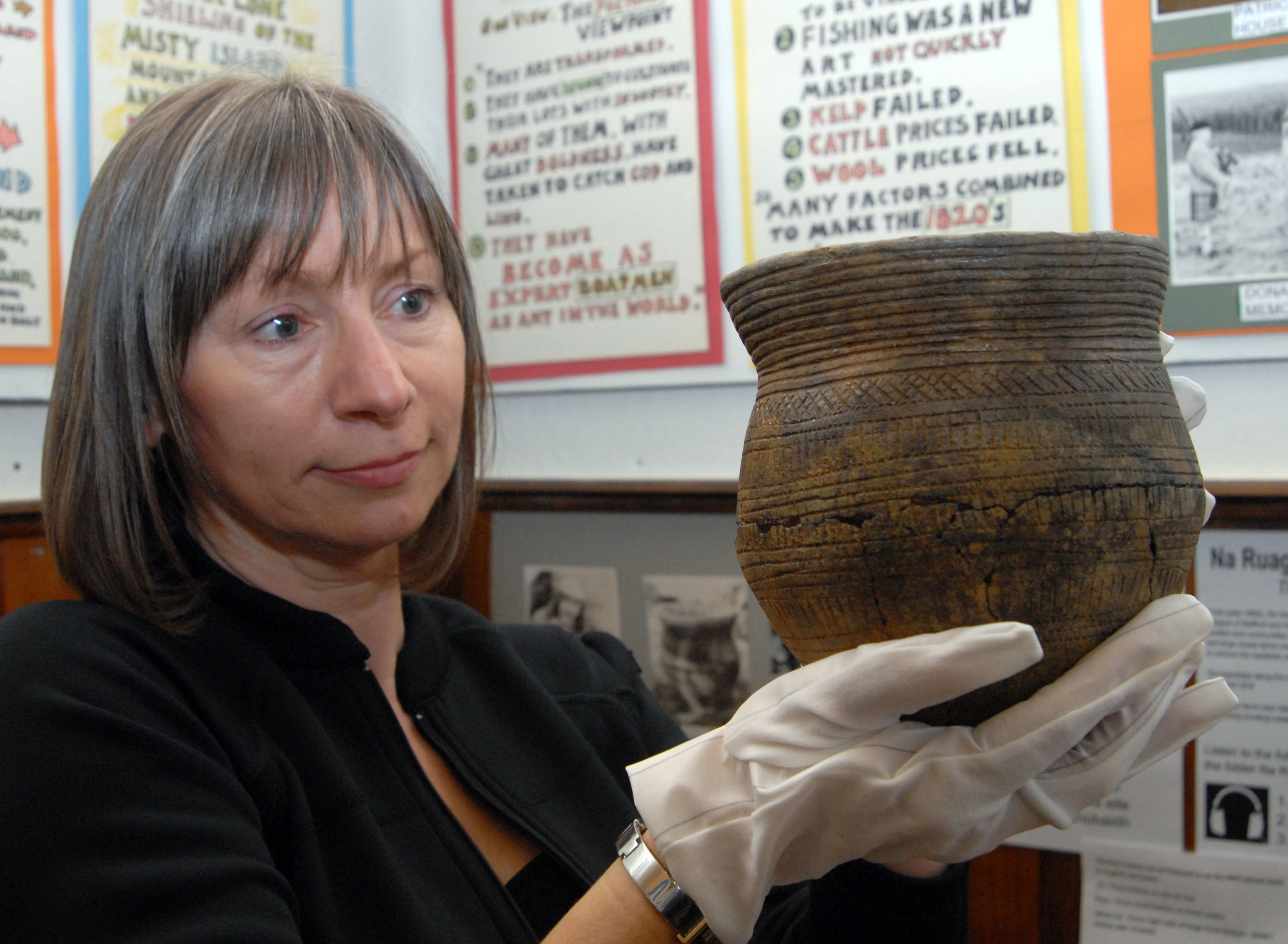 Beaker - object from Strathnaver Museum with volunteer holding