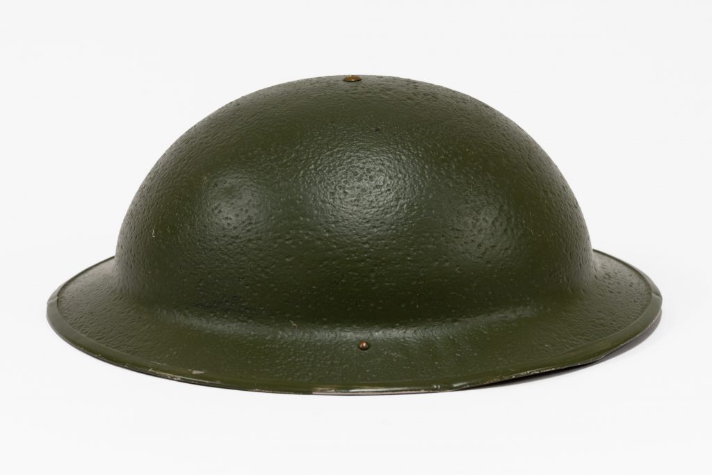 Metal WW2 round, green hat.